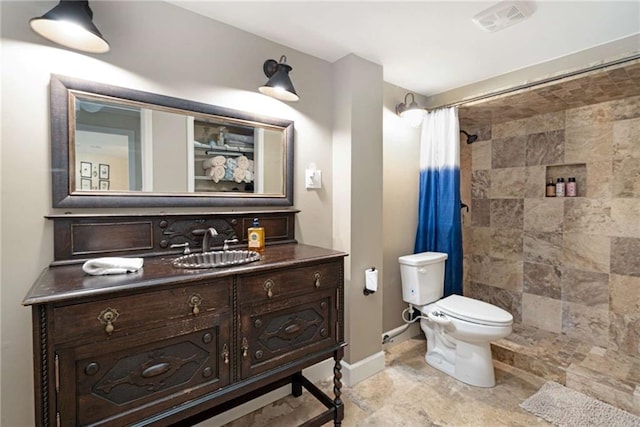 bathroom featuring vanity, curtained shower, and toilet