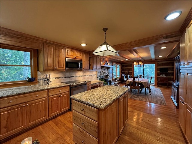 kitchen with pendant lighting, light hardwood / wood-style flooring, and a healthy amount of sunlight