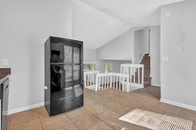 5338 Timor Trl, Lithonia, GA 30038 - unfurnished room with lofted ceiling, baseboards, tile patterned flooring, a textured ceiling, and a smoke detector
