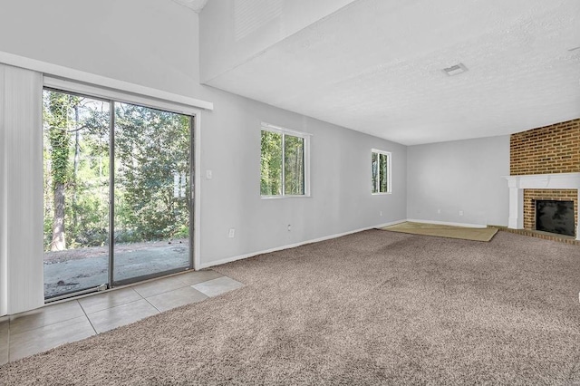 5338 Timor Trl, Lithonia, GA 30038 - unfurnished living room featuring carpet, a brick fireplace, a textured ceiling, baseboards, and tile patterned floors