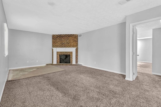 5338 Timor Trl, Lithonia, GA 30038 - unfurnished living room with carpet, a textured ceiling, a fireplace, and baseboards