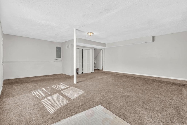 5338 Timor Trl, Lithonia, GA 30038 - basement featuring a textured ceiling, carpet floors, electric panel, and baseboards