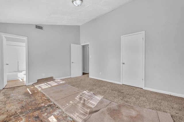 5338 Timor Trl, Lithonia, GA 30038 - unfurnished bedroom with lofted ceiling, connected bathroom, and carpet flooring