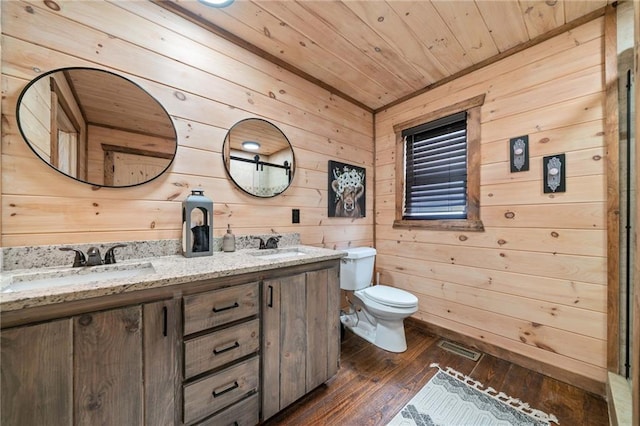 full bathroom with toilet, wood ceiling, a sink, and wood finished floors