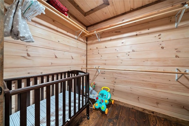 bedroom with wood ceiling, wooden walls, and wood finished floors