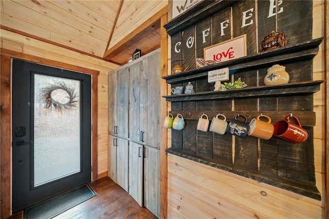 mudroom featuring wood walls, wood ceiling, and dark wood-style flooring