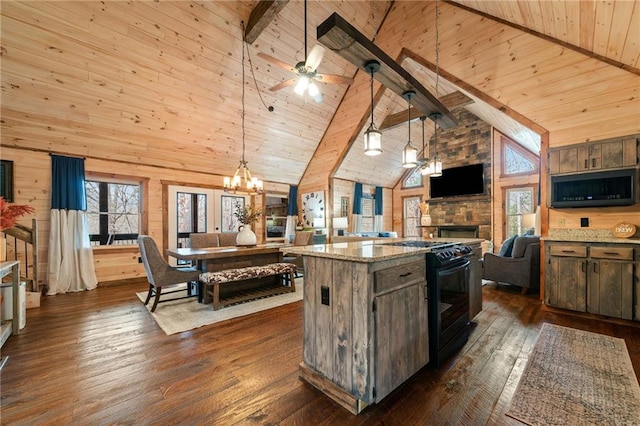 kitchen with open floor plan, gas stove, dark wood finished floors, and beam ceiling