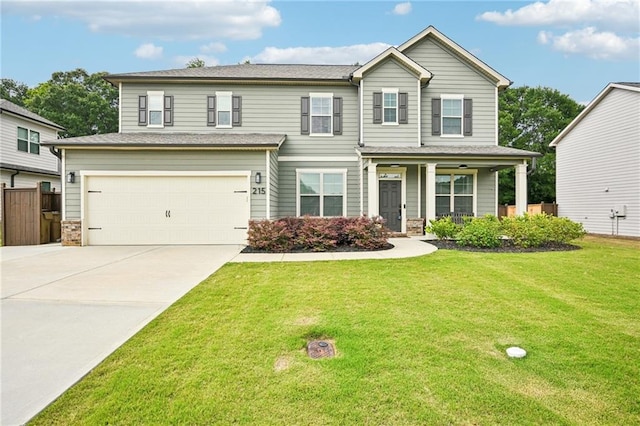 215 Dragonfly Way, Winder, GA 30680 - view of front of property with an attached garage, driveway, a porch, and stone siding