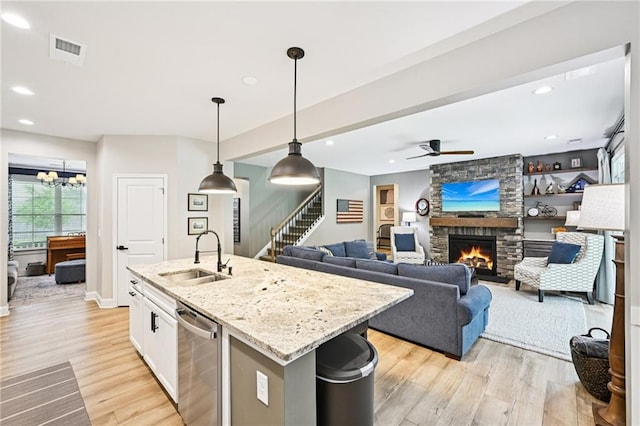 215 Dragonfly Way, Winder, GA 30680 - kitchen with a sink, dishwasher, a stone fireplace, light wood finished floors, and recessed lighting