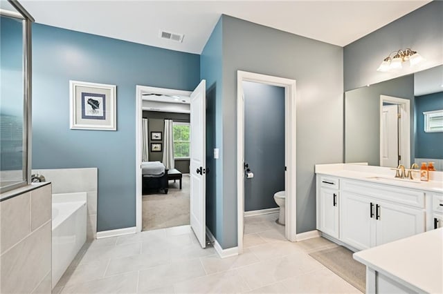 215 Dragonfly Way, Winder, GA 30680 - ensuite bathroom featuring a bath, vanity, toilet, baseboards, and tile patterned flooring
