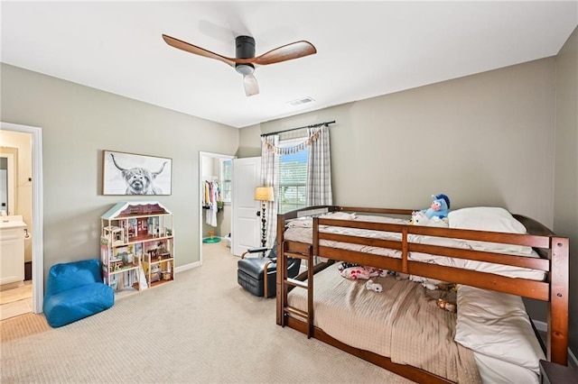 215 Dragonfly Way, Winder, GA 30680 - bedroom featuring a spacious closet, light carpet, a ceiling fan, baseboards, and ensuite bath