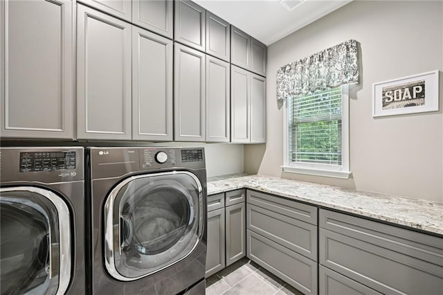 215 Dragonfly Way, Winder, GA 30680 - laundry room featuring cabinet space, washer and clothes dryer, and light tile patterned floors