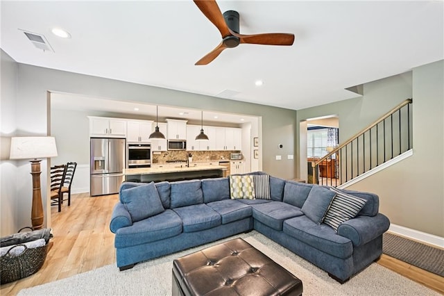 215 Dragonfly Way, Winder, GA 30680 - living area with a ceiling fan, light wood-type flooring, recessed lighting, stairway, and baseboards
