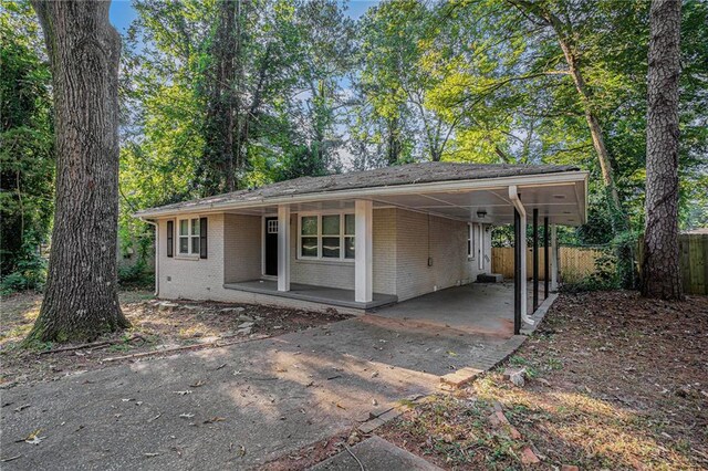 ranch-style home featuring a carport