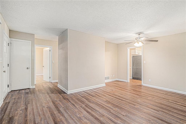 empty room featuring ceiling fan, dark wood-type flooring, and crown molding