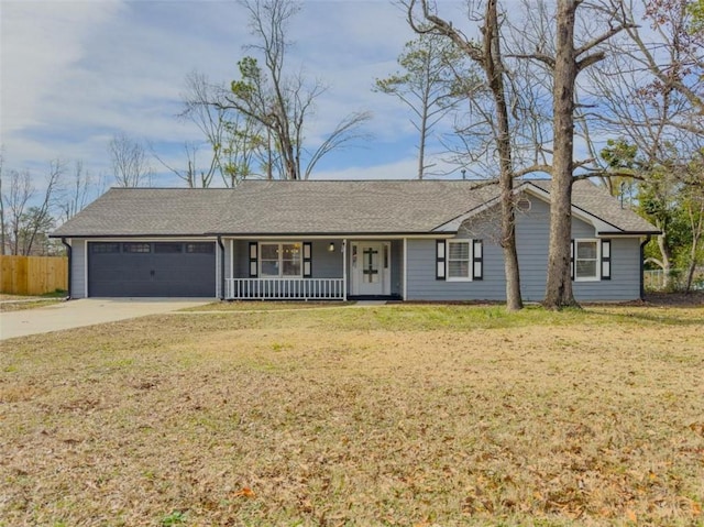 single story home featuring a porch, a garage, and a front yard