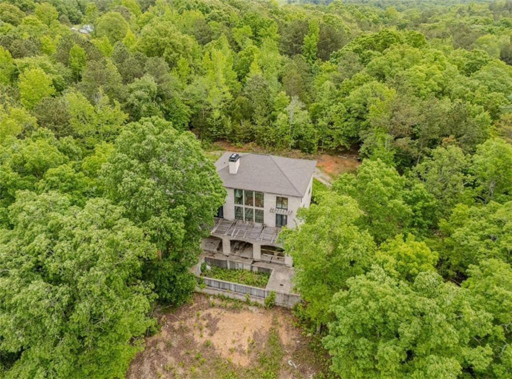 aerial view featuring a wooded view