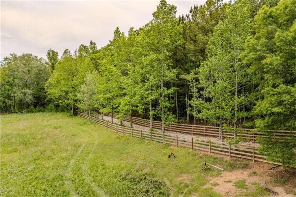 view of yard with fence and a view of trees