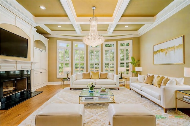 living area with beam ceiling, a notable chandelier, light wood-style flooring, a premium fireplace, and baseboards