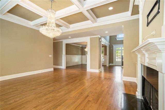 unfurnished living room featuring coffered ceiling, a fireplace with flush hearth, wood finished floors, beamed ceiling, and an inviting chandelier