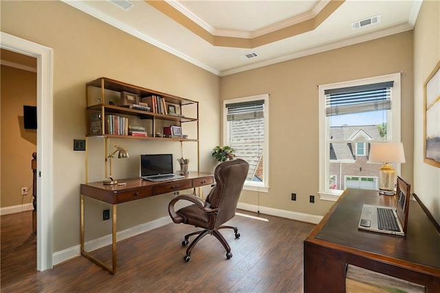 office space with visible vents, dark wood finished floors, crown molding, and a raised ceiling