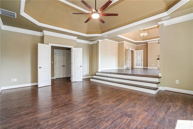 unfurnished room with wood finished floors, visible vents, baseboards, a tray ceiling, and crown molding