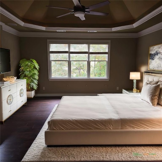 bedroom with ornamental molding, a raised ceiling, ceiling fan, and dark wood-style flooring