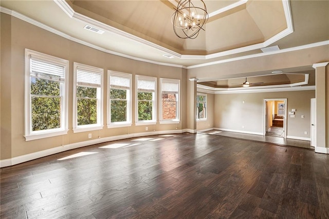 unfurnished room featuring ornamental molding, a tray ceiling, a healthy amount of sunlight, and wood finished floors