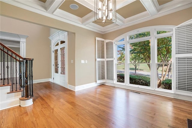 foyer with visible vents, an inviting chandelier, wood finished floors, baseboards, and stairs