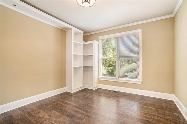 unfurnished room with crown molding, dark wood-style flooring, visible vents, and baseboards