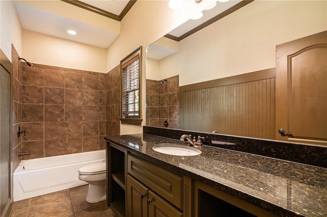 full bath featuring crown molding, toilet, washtub / shower combination, vanity, and tile patterned floors