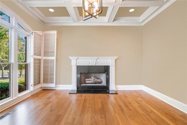 unfurnished living room featuring light wood-style flooring, baseboards, and a fireplace with raised hearth