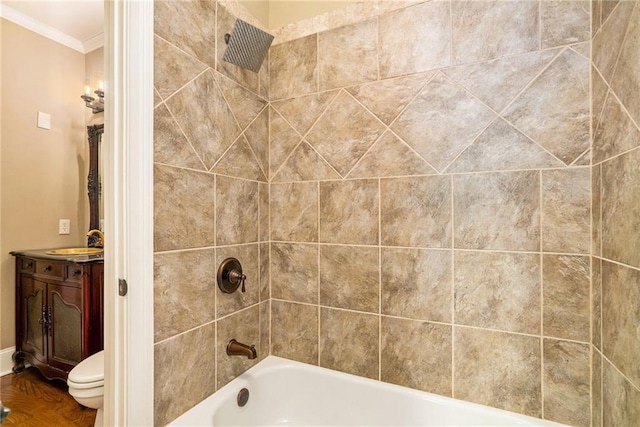 bathroom featuring toilet, crown molding, vanity, and shower / tub combination