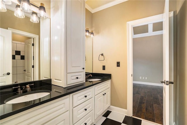 full bathroom with ornamental molding, a sink, baseboards, and double vanity