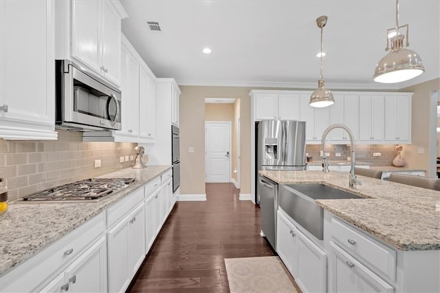 12 Pine St, Roswell, GA 30075 - kitchen featuring stainless steel appliances, a sink, backsplash, white cabinetry, and recessed lighting