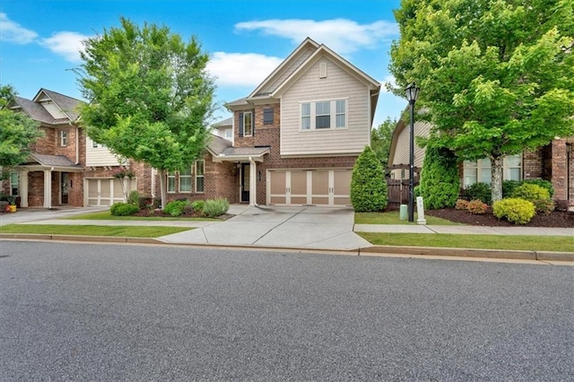 12 Pine St, Roswell, GA 30075 - view of front of property with an attached garage, concrete driveway, and brick siding