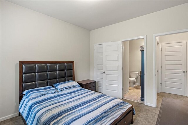 carpeted bedroom with connected bathroom