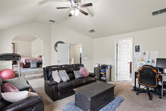 carpeted living room with ceiling fan and lofted ceiling