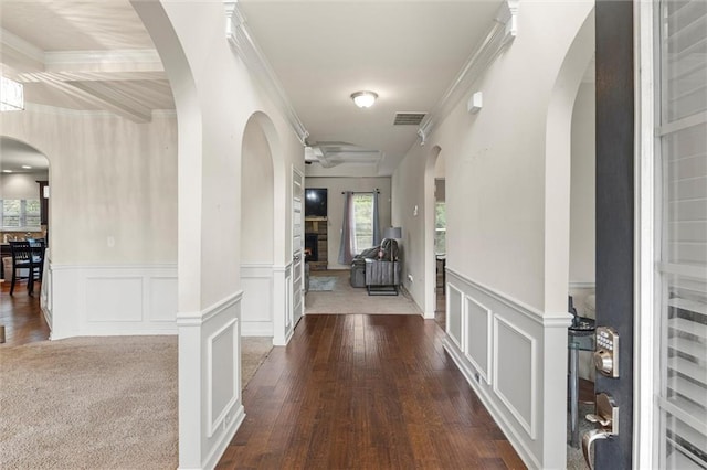 hallway with hardwood / wood-style flooring and crown molding