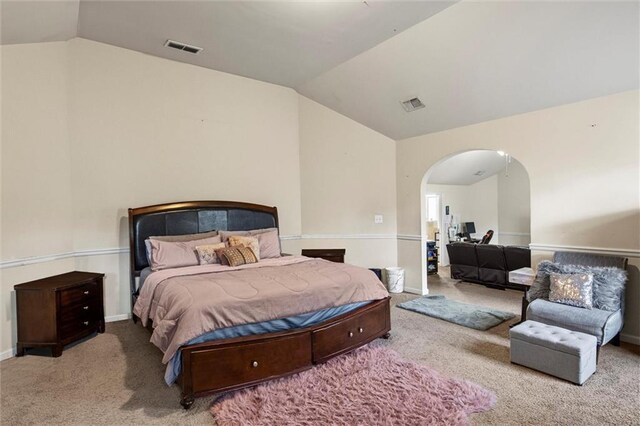 carpeted bedroom featuring lofted ceiling