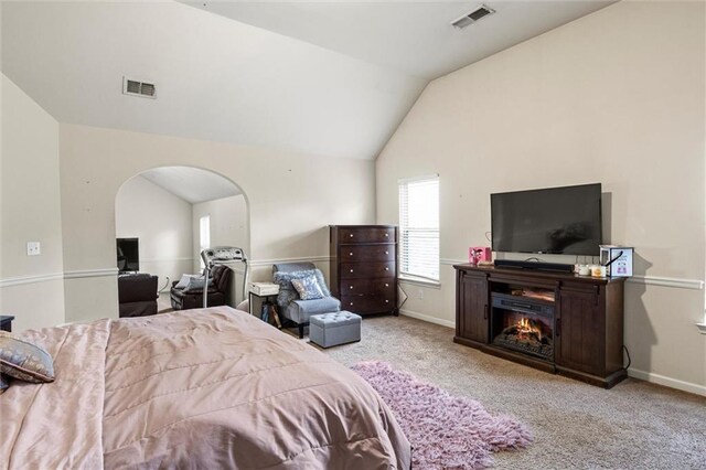 living room featuring carpet floors, ceiling fan, and lofted ceiling