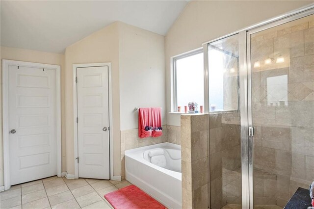 bathroom featuring separate shower and tub, tile patterned flooring, and lofted ceiling