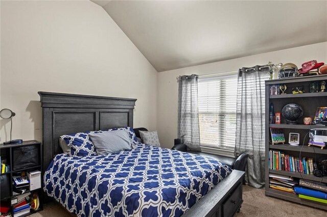 carpeted bedroom with vaulted ceiling