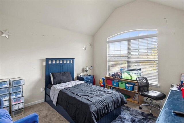 carpeted bedroom featuring vaulted ceiling