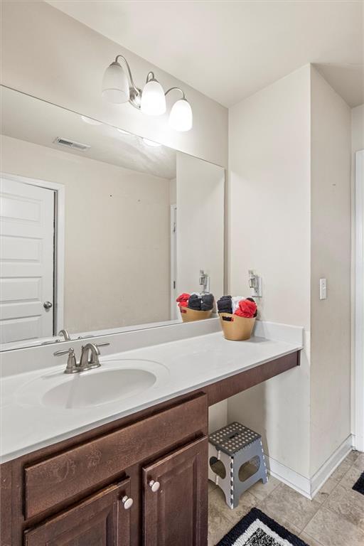 bathroom featuring tile patterned flooring and vanity