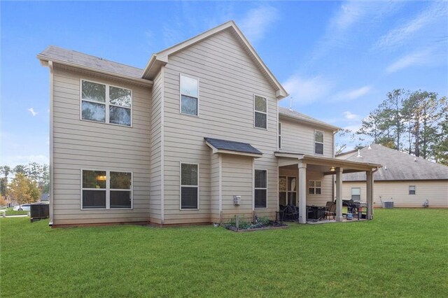 back of property featuring a patio area and a yard