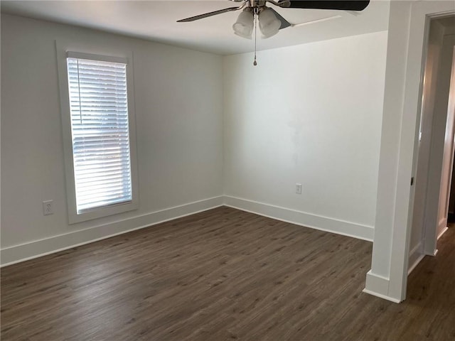 unfurnished room featuring dark hardwood / wood-style floors and ceiling fan