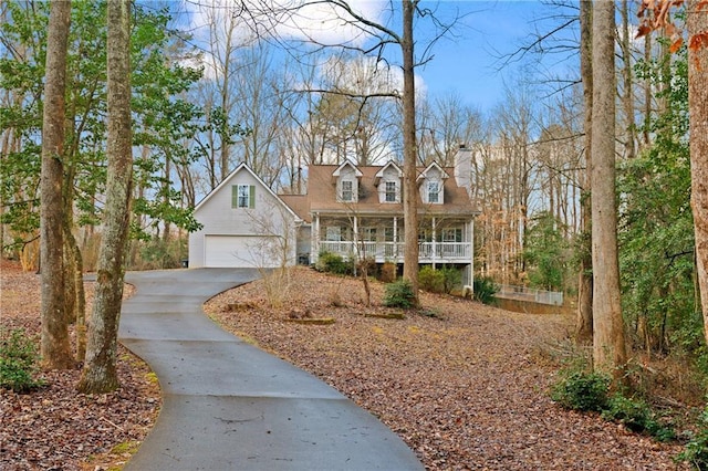 cape cod-style house featuring covered porch