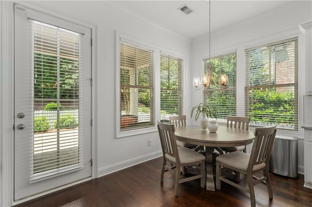 dining area with a chandelier, ornamental molding, baseboards, visible vents, and dark wood-style floors