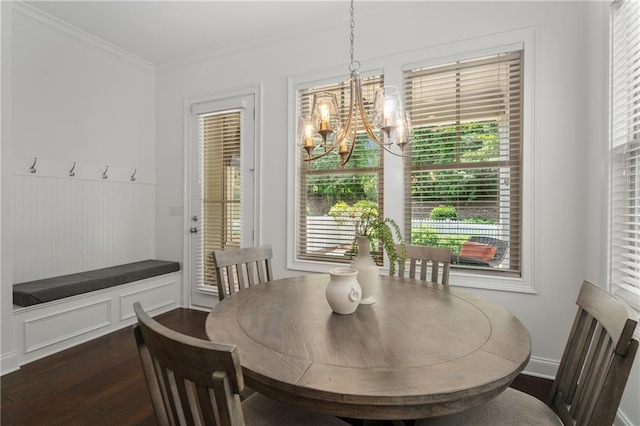 dining area with crown molding, a notable chandelier, plenty of natural light, and dark wood finished floors